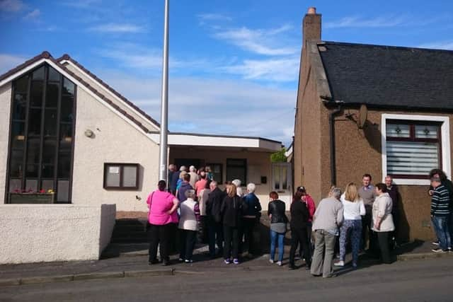 People queue to get into the meeting